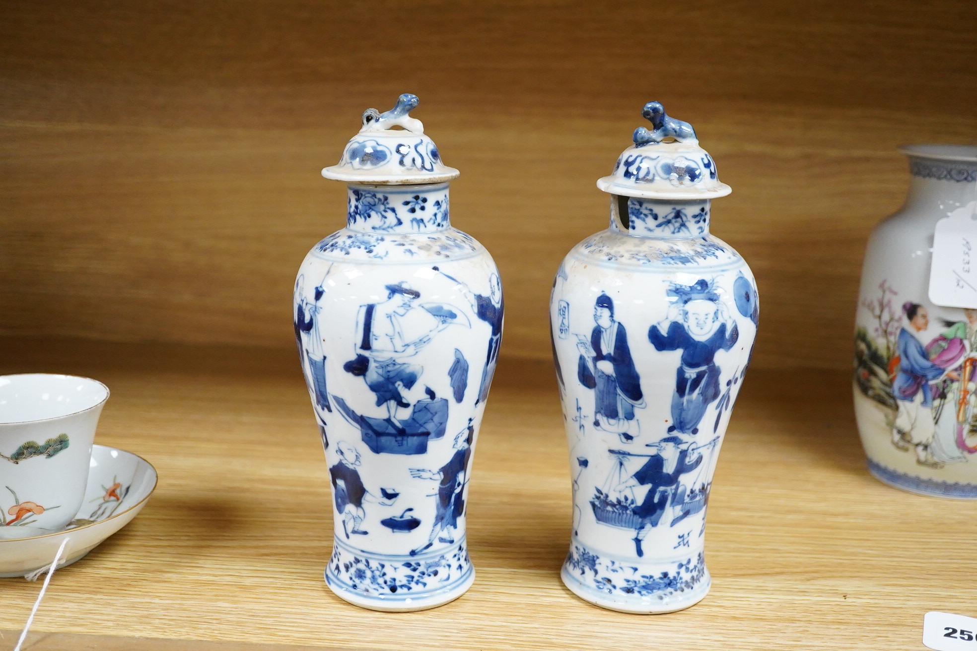A pair of 19th century Chinese blue and white vases and covers. 22.5cm high